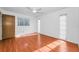 Bedroom featuring wood floors, bright natural light from two windows, and a ceiling fan at 2559 Redwood Cir, Clearwater, FL 33763