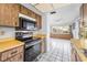 Well-equipped kitchen with a black range, microwave, and white tile floors at 2559 Redwood Cir, Clearwater, FL 33763