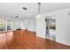 Open-concept living room with hardwood floors, a ceiling fan, and access to the kitchen at 2559 Redwood Cir, Clearwater, FL 33763