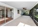 Enclosed patio with ceiling fan, tiled floor, and sliding doors to the home interior at 2559 Redwood Cir, Clearwater, FL 33763