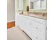 Bathroom with white vanity, granite countertop, and lots of cabinet space at 2814 Highlands Blvd # B, Palm Harbor, FL 34684