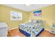 Bright bedroom featuring a queen-size bed with nautical-themed decor and plantation shutters at 2814 Highlands Blvd # B, Palm Harbor, FL 34684