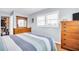 Bright bedroom with white plantation shutters, wood floors, and matching dressers at 2814 Highlands Blvd # B, Palm Harbor, FL 34684