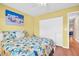 Bright bedroom featuring a queen-size bed with nautical-themed decor, closet, and hardwood floors at 2814 Highlands Blvd # B, Palm Harbor, FL 34684