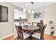 Cozy dining area featuring a round wooden table, seating for four, and stylish pendant lighting at 2814 Highlands Blvd # B, Palm Harbor, FL 34684