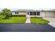 Villa with landscaped front yard, sidewalk and attached garage providing convenience and aesthetic appeal at 2814 Highlands Blvd # B, Palm Harbor, FL 34684