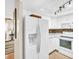 Well-lit kitchen with white cabinetry and appliances, mosaic backsplash and modern track lighting at 2814 Highlands Blvd # B, Palm Harbor, FL 34684