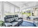 Bright sunroom features ample windows, comfortable seating, and a ceiling fan for a relaxing ambiance at 2814 Highlands Blvd # B, Palm Harbor, FL 34684