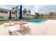 Community pool surrounded by palm trees and seating, perfect for relaxing and socializing at 2900 45Th S St # 26, Gulfport, FL 33711