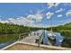 Picturesque waterfront view showcasing a private wooden dock and a small sailboat with lush greenery surrounding the calm waters at 2900 45Th S St # 26, Gulfport, FL 33711