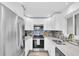 Modern kitchen with stainless steel appliances, white cabinetry, and stylish backsplash, offering a sleek cooking space at 2900 45Th S St # 26, Gulfport, FL 33711
