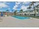 Community pool with a patio and lounge chairs in a tropical setting at 2900 45Th S St # 26, Gulfport, FL 33711