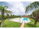 Inviting pool area surrounded by lush landscaping with tropical trees at 2900 45Th S St # 26, Gulfport, FL 33711