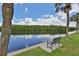 Bench overlooking the calm river with lush green foliage and clear blue sky at 2900 45Th S St # 26, Gulfport, FL 33711