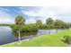 Breathtaking waterfront view featuring swaying palm trees, a tranquil canal, and lush greenery, creating a serene and picturesque scene at 2900 45Th S St # 26, Gulfport, FL 33711