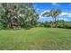 Beautiful backyard featuring a lush lawn and mature trees at 302 Old Mulrennan Rd, Valrico, FL 33594