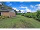 Side yard features a grassy lawn and views of nearby foliage at 302 Old Mulrennan Rd, Valrico, FL 33594