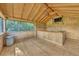 Interior of bar shed with wood walls and floors, bar and ceiling fan at 302 Old Mulrennan Rd, Valrico, FL 33594