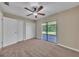 Bedroom with ceiling fan, closet, and sliding doors to screened in lanai at 302 Old Mulrennan Rd, Valrico, FL 33594