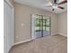 Bright bedroom featuring neutral carpet, ceiling fan, and sliding doors to the lanai at 302 Old Mulrennan Rd, Valrico, FL 33594