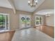 Elegant foyer featuring tiled and wood floors and a chandelier at 302 Old Mulrennan Rd, Valrico, FL 33594