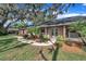 Charming brick home featuring a walkway with a double door entry and lush landscaping at 302 Old Mulrennan Rd, Valrico, FL 33594