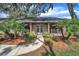 Charming brick home featuring a walkway with a double door entry and lush landscaping at 302 Old Mulrennan Rd, Valrico, FL 33594