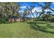 Sprawling single-story brick home with expansive front lawn and mature shade trees at 302 Old Mulrennan Rd, Valrico, FL 33594
