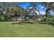 Sprawling single-story brick home with expansive front lawn and mature shade trees at 302 Old Mulrennan Rd, Valrico, FL 33594