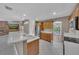 Eat-in kitchen with stainless appliances and ample counter space overlooking the living room at 302 Old Mulrennan Rd, Valrico, FL 33594