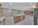 Kitchen with breakfast bar overlooking an open-concept living room with a fireplace at 302 Old Mulrennan Rd, Valrico, FL 33594