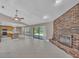 Expansive living room flows into a kitchen with brick fireplace feature at 302 Old Mulrennan Rd, Valrico, FL 33594