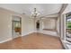 Open-concept living room with hardwood flooring, arched doorways, and neutral walls at 302 Old Mulrennan Rd, Valrico, FL 33594
