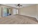 Spacious main bedroom with neutral carpet, ceiling fan, and sliding doors to lanai at 302 Old Mulrennan Rd, Valrico, FL 33594