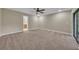 Spacious main bedroom with neutral carpet, ceiling fan, and sliding doors to lanai at 302 Old Mulrennan Rd, Valrico, FL 33594