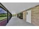 Long screened patio with a brick exterior, views of the backyard, and a white ceiling at 302 Old Mulrennan Rd, Valrico, FL 33594