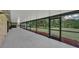 Long screened patio overlooking a lush, expansive backyard and a wooden shed at 302 Old Mulrennan Rd, Valrico, FL 33594