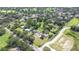 Aerial view of neighborhood with mature trees, homes and surrounding areas at 3125 S Miller Rd, Valrico, FL 33596