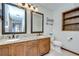 Bathroom featuring dual sinks with granite countertops and wood cabinets at 3125 S Miller Rd, Valrico, FL 33596