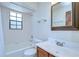 Bathroom with a tub, shower, tile surround, vanity and a large mirror at 3125 S Miller Rd, Valrico, FL 33596
