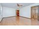 Spacious bedroom featuring hardwood floors, ceiling fan, and wood trim at 3125 S Miller Rd, Valrico, FL 33596