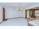 Dining room with wood door and trim, chandelier, and access to sunroom at 3125 S Miller Rd, Valrico, FL 33596