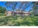 Charming home with a brick exterior, a well-maintained lawn, and mature trees offering shade at 3125 S Miller Rd, Valrico, FL 33596