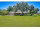 Charming brick home with a well-manicured lawn and mature trees, creating a serene and inviting curb appeal at 3125 S Miller Rd, Valrico, FL 33596