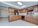 Efficient kitchen with wood cabinets, stone countertops, and black appliances at 3125 S Miller Rd, Valrico, FL 33596
