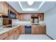 Efficient kitchen with wood cabinetry, stone countertops, and modern appliances at 3125 S Miller Rd, Valrico, FL 33596
