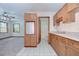 Kitchenette area with wooden cabinets and a view of a living area at 3125 S Miller Rd, Valrico, FL 33596