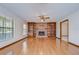 Inviting living room with hardwood floors, a brick fireplace, and built-in bookshelves at 3125 S Miller Rd, Valrico, FL 33596