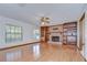 Bright living room with hardwood floors, a brick fireplace, and built-in shelving at 3125 S Miller Rd, Valrico, FL 33596