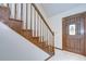 Classic wooden staircase leading to the upper level, with decorative wood trim at 3125 S Miller Rd, Valrico, FL 33596